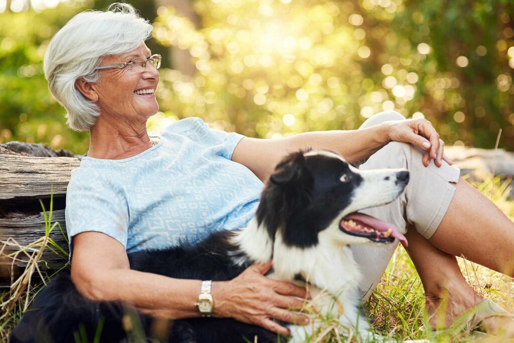 senior lady smiling with her dog