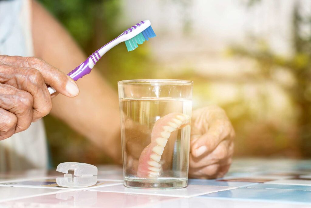 cleaning your dentures in a glass of water